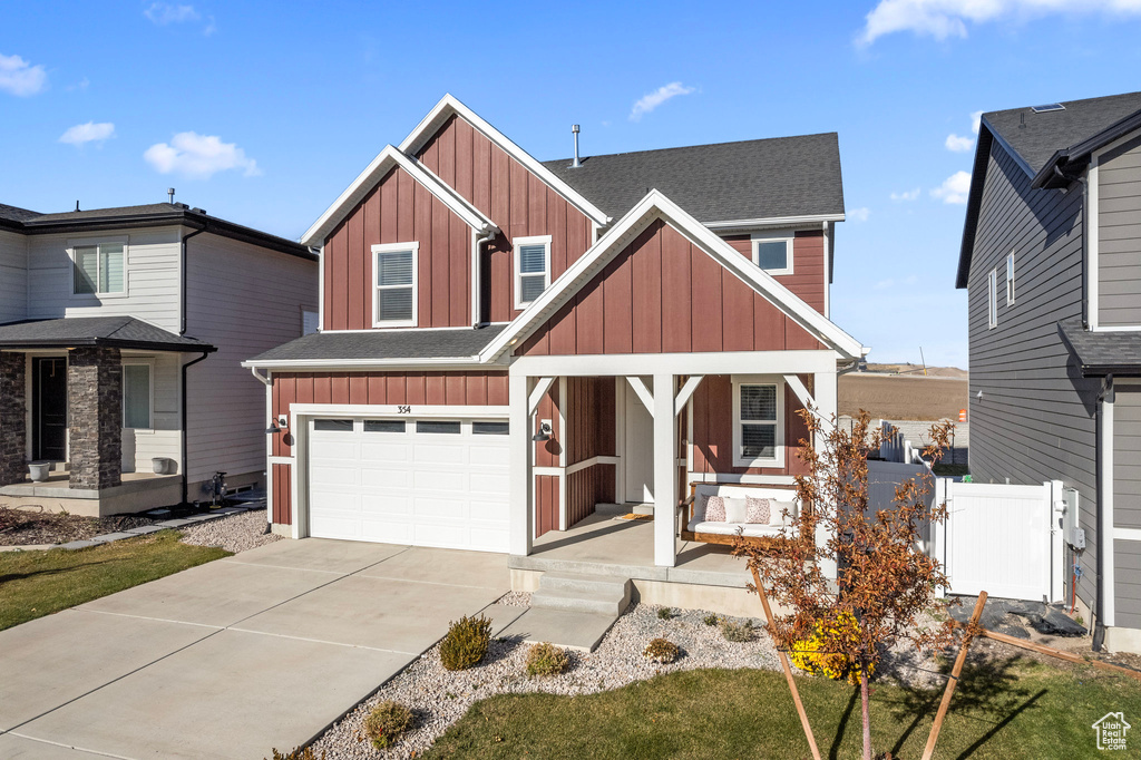 View of front of home with covered porch and a garage