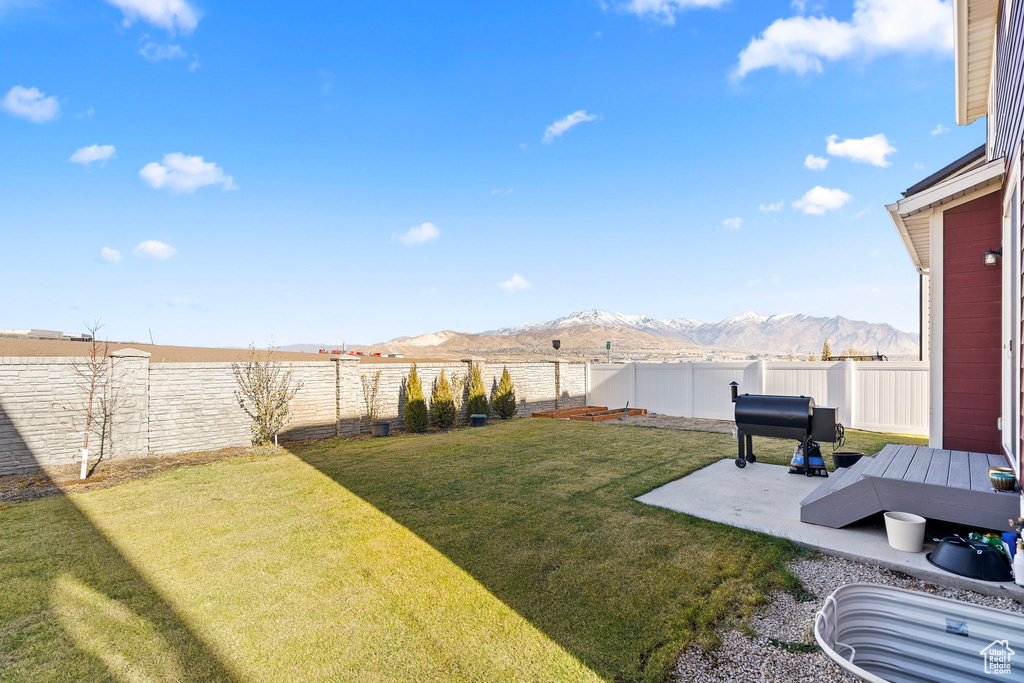 View of yard featuring a mountain view and a patio