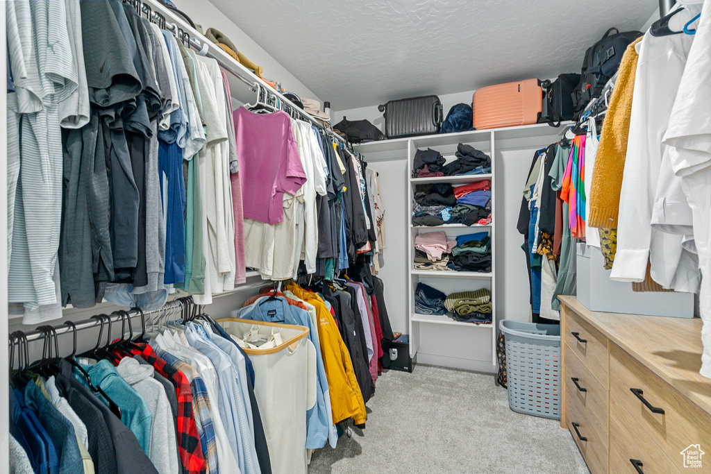 Spacious closet with light colored carpet