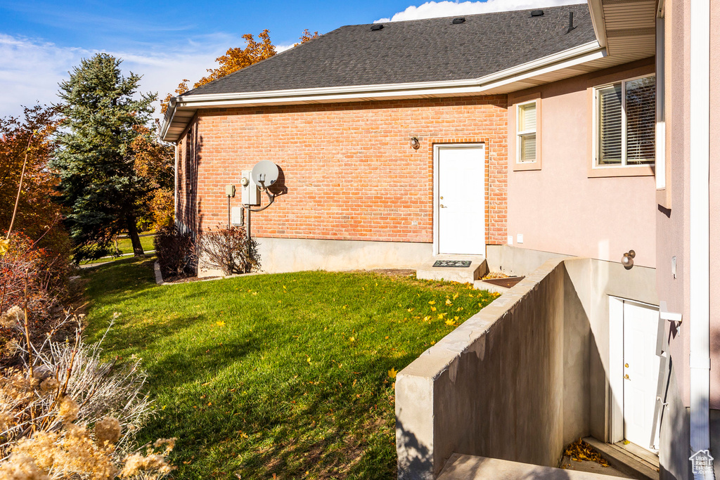 Rear view of property featuring a yard