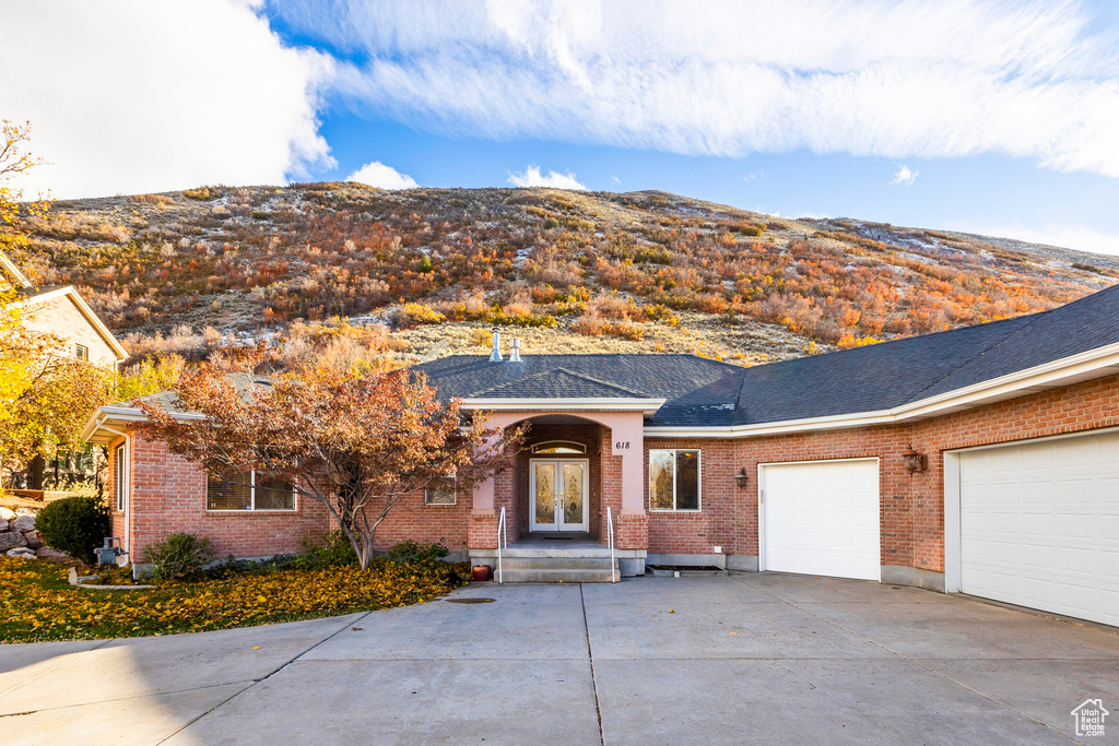 Ranch-style house featuring a mountain view and a garage