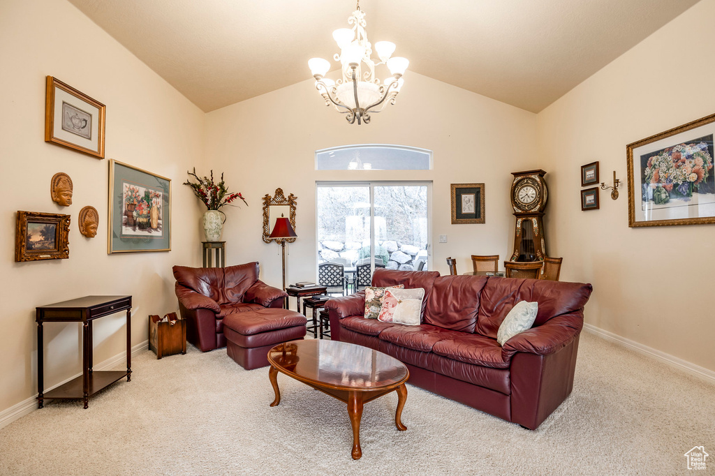 Carpeted living room featuring lofted ceiling and a chandelier