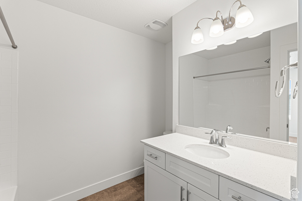 Bathroom featuring vanity and bathing tub / shower combination