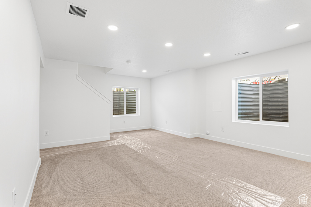 Spare room featuring light carpet and recessed lighting