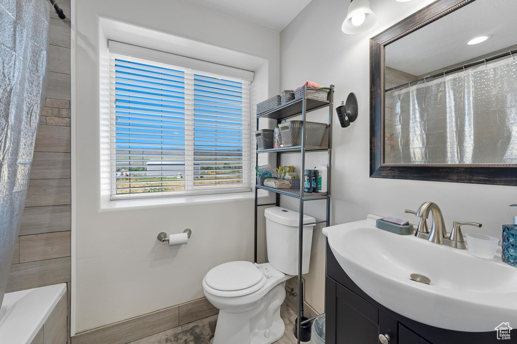 Full bathroom featuring tile patterned flooring, shower / tub combo, vanity, and toilet