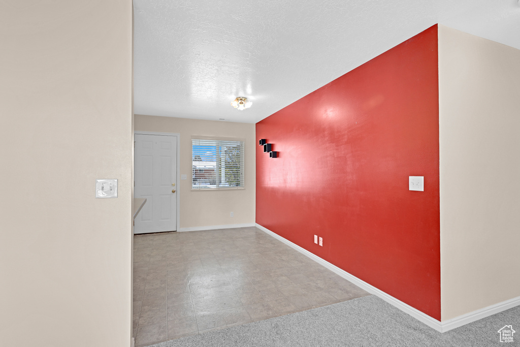 Empty room featuring a textured ceiling