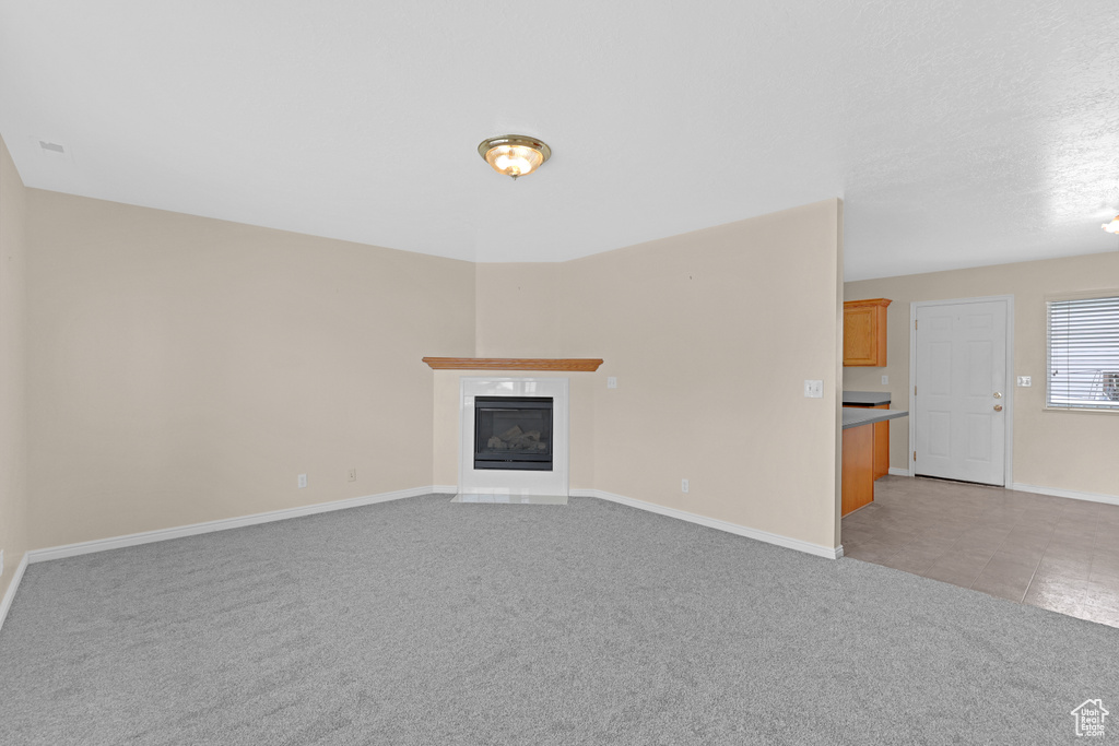Unfurnished living room with light carpet