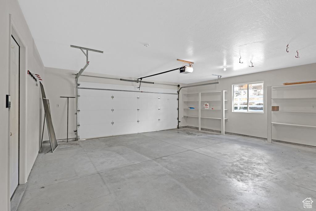 Garage featuring a garage door opener