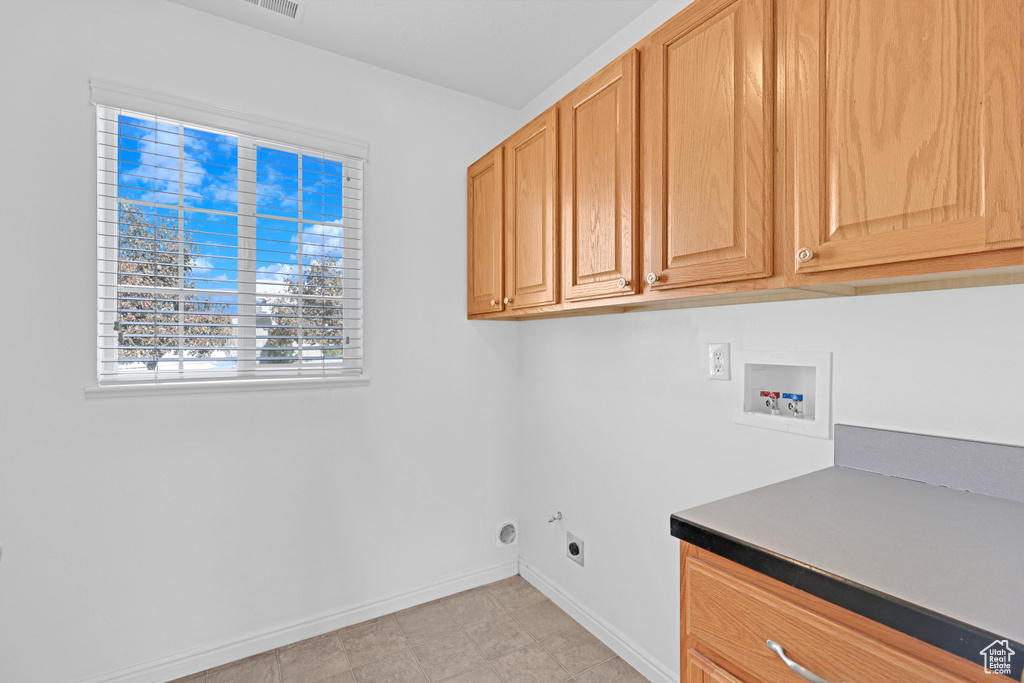 Laundry area featuring washer hookup, hookup for an electric dryer, and cabinets