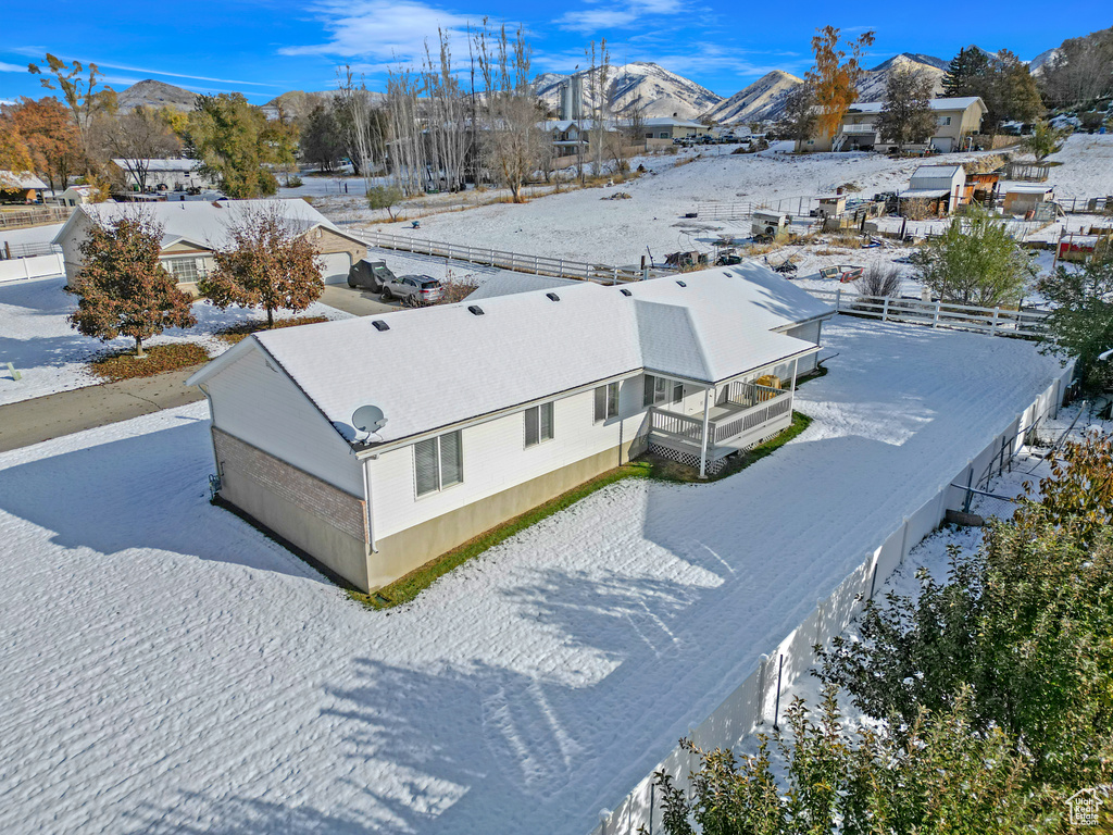 Snowy aerial view featuring a mountain view