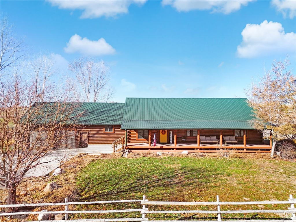 Log-style house with a porch