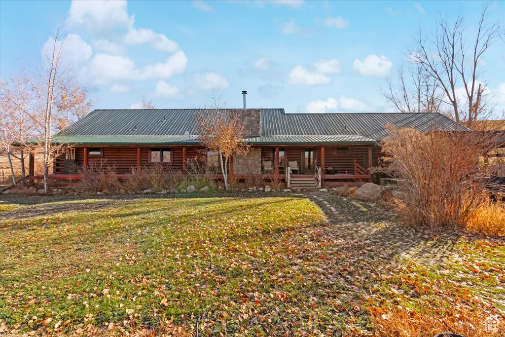 Back of house with a lawn