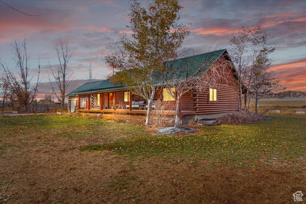 View of front of house featuring a lawn and a porch
