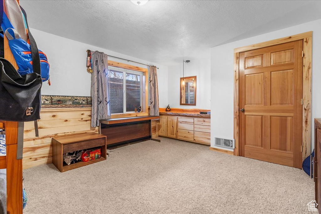 Bedroom featuring carpet and a textured ceiling