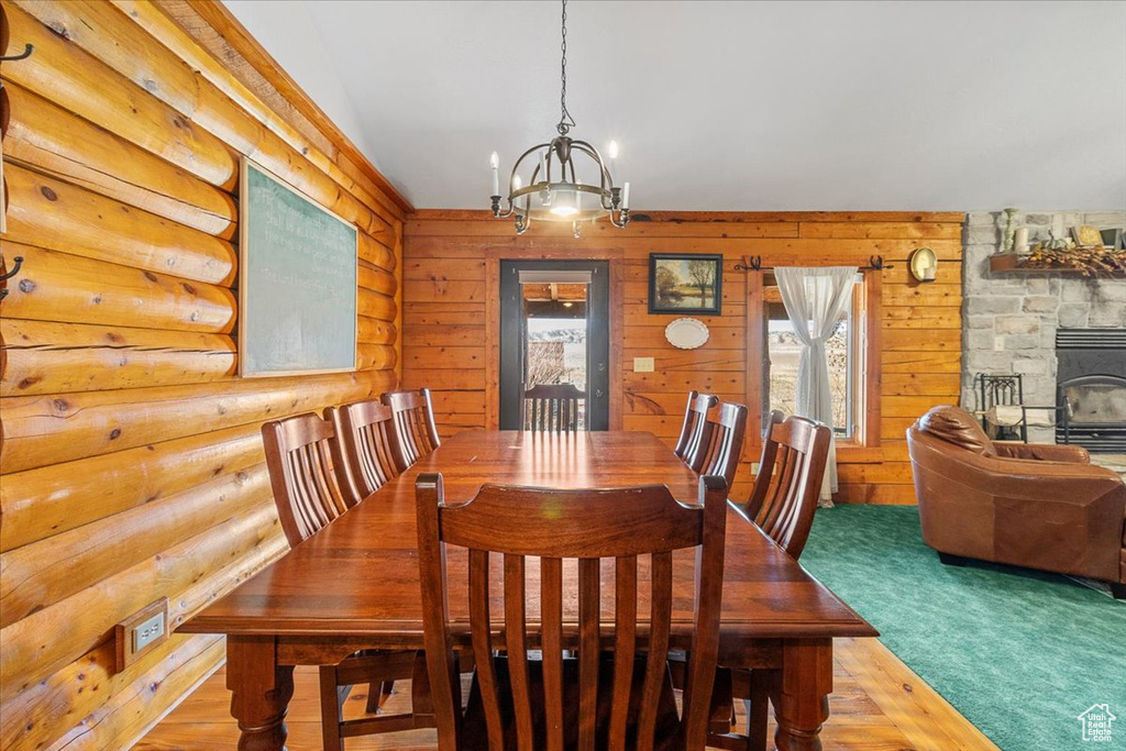 Carpeted dining area with an inviting chandelier