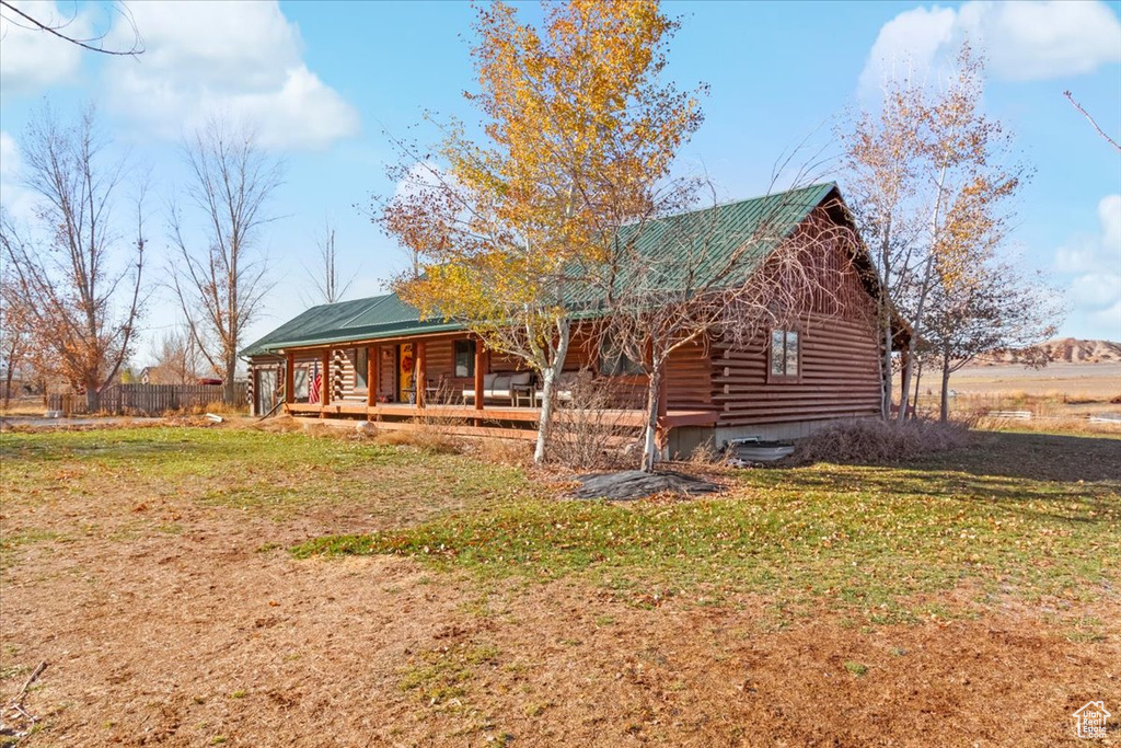 Exterior space with a porch and a yard