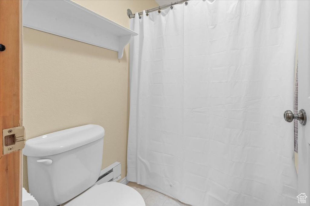 Bathroom featuring toilet and baseboard heating