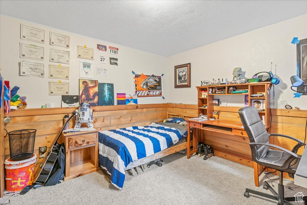 Carpeted bedroom featuring a textured ceiling