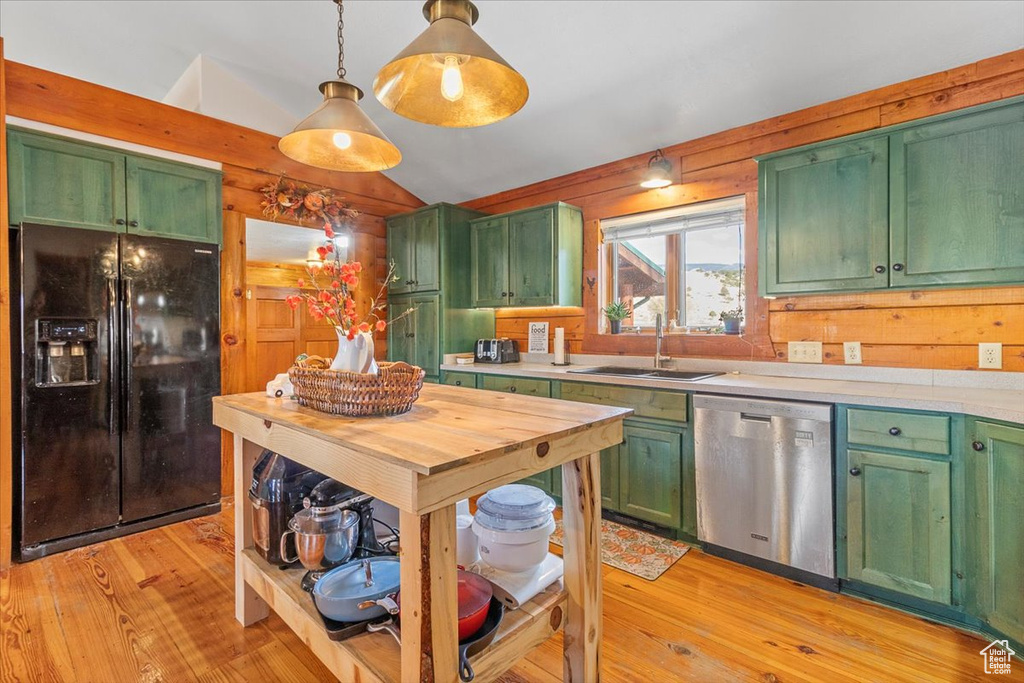 Kitchen with dishwasher, decorative light fixtures, black fridge, and green cabinetry