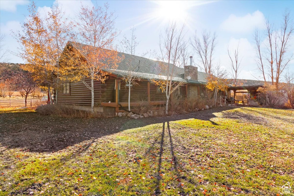 Back of house featuring a yard