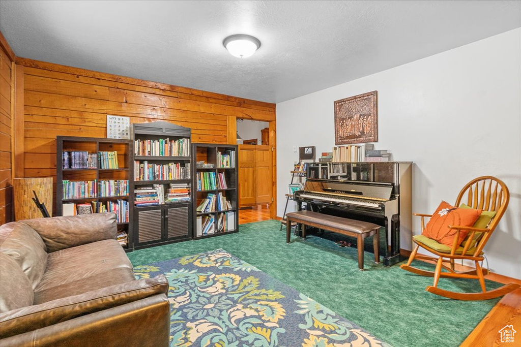 Sitting room featuring hardwood / wood-style flooring and wood walls