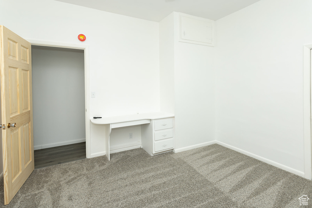 Unfurnished office with dark carpet