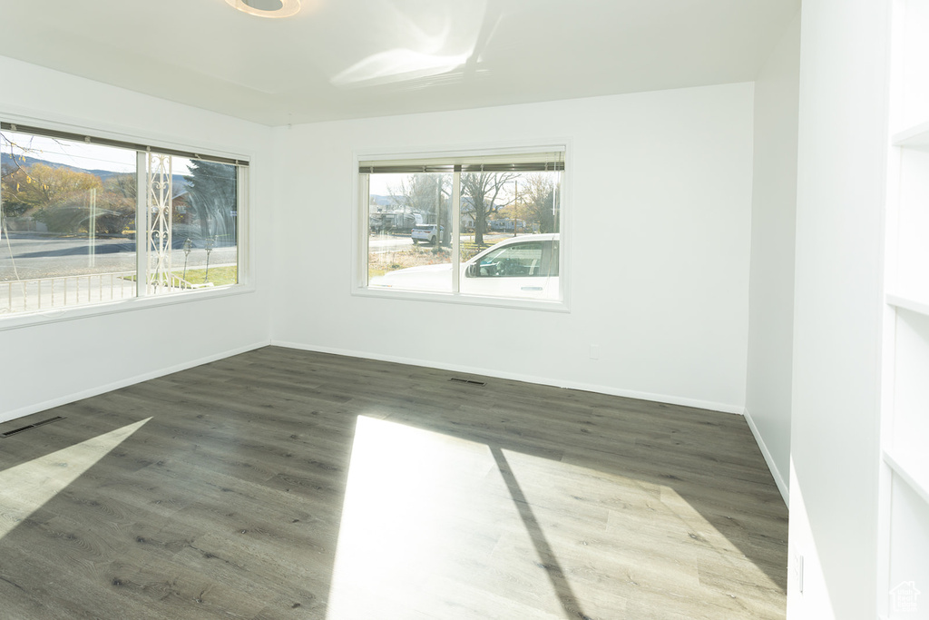 Spare room featuring dark hardwood / wood-style floors