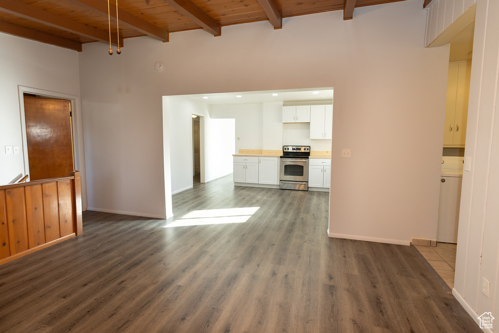 Unfurnished living room with beam ceiling, wooden ceiling, and dark wood-type flooring