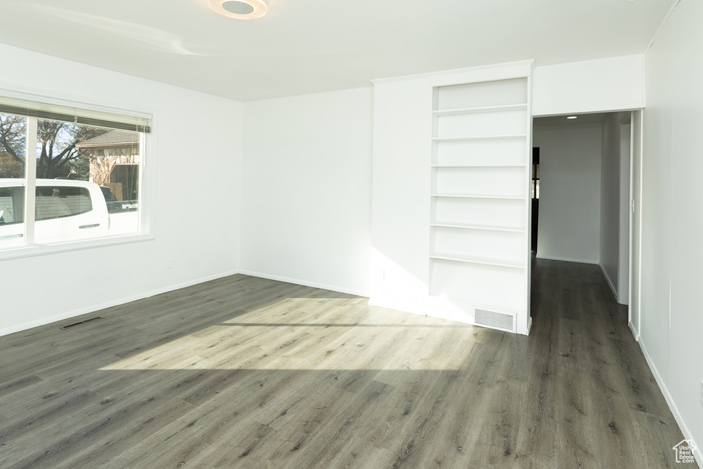 Unfurnished room featuring dark hardwood / wood-style flooring