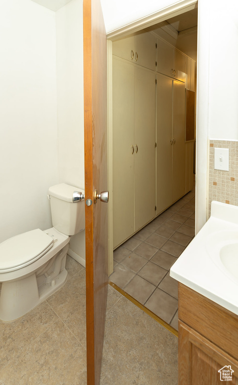 Bathroom featuring tile patterned flooring, vanity, and toilet