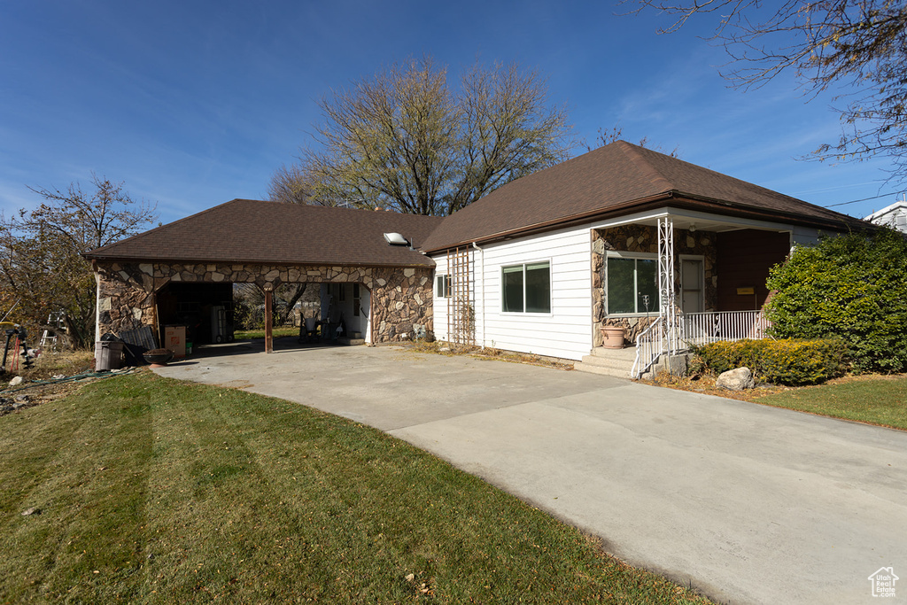 View of front of house featuring a front lawn and a carport