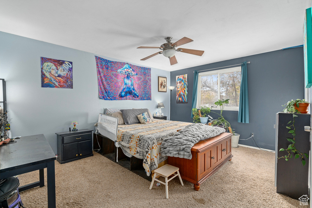 Carpeted bedroom featuring ceiling fan