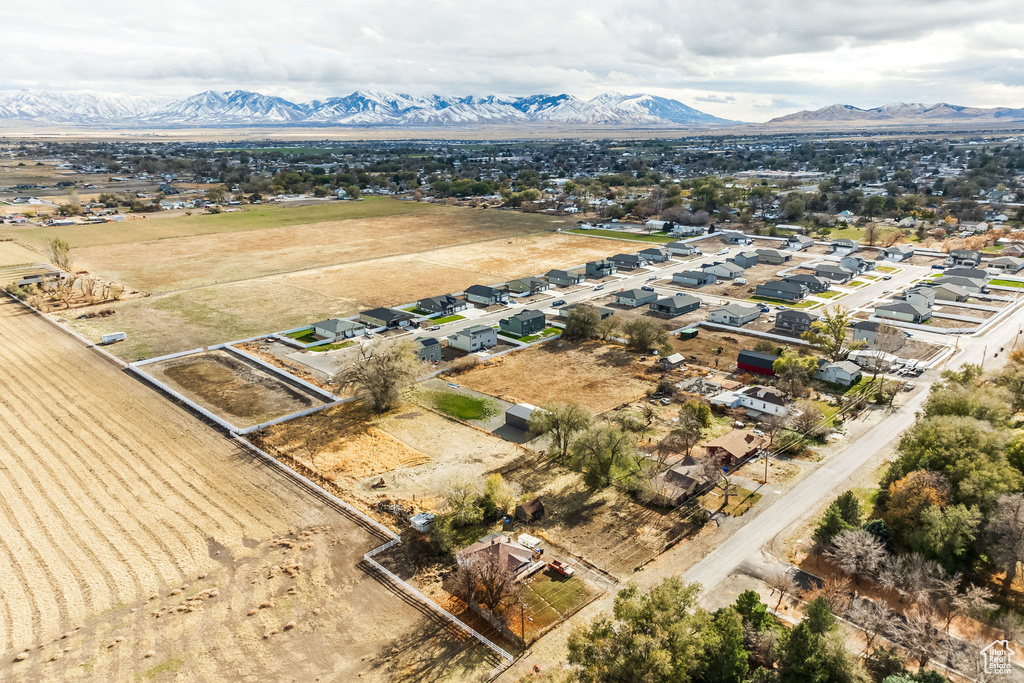 Aerial view of sparsely populated area with a mountainous background and nearby suburban area