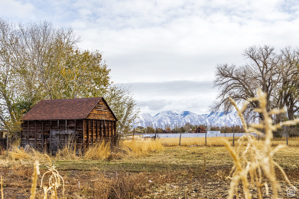 View of yard with a mountain view and an outdoor structure