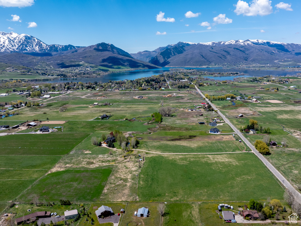 Drone / aerial view featuring a water and mountain view
