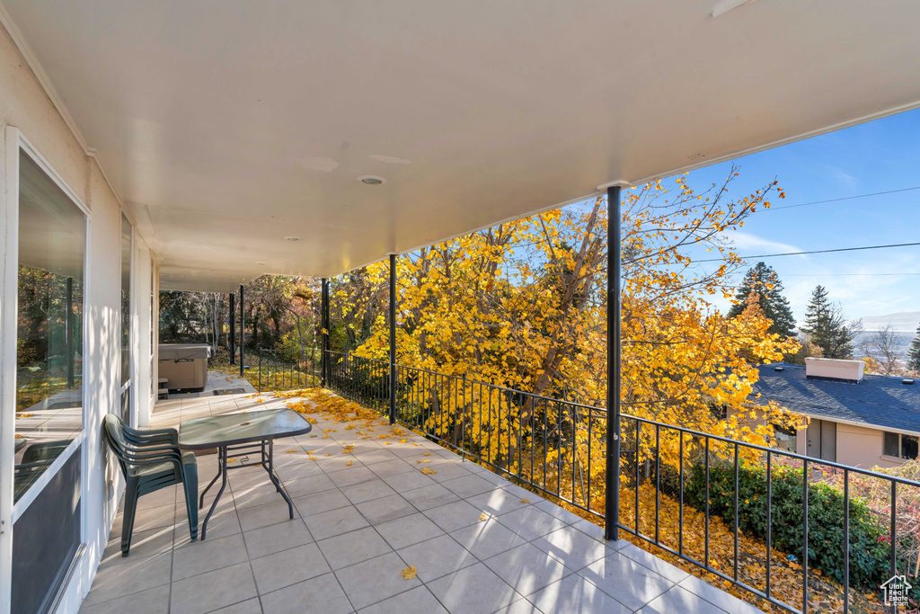 View of patio / terrace featuring a balcony and a hot tub