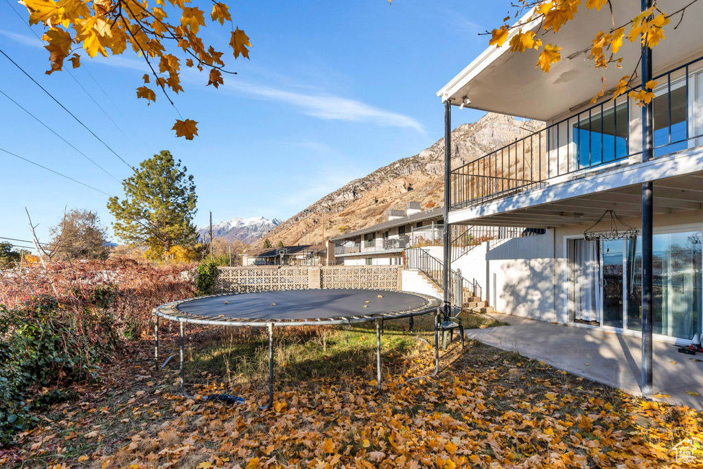 View of yard featuring a mountain view and a trampoline