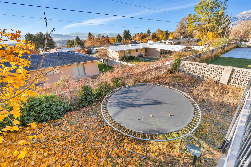 View of yard featuring a mountain view and a trampoline