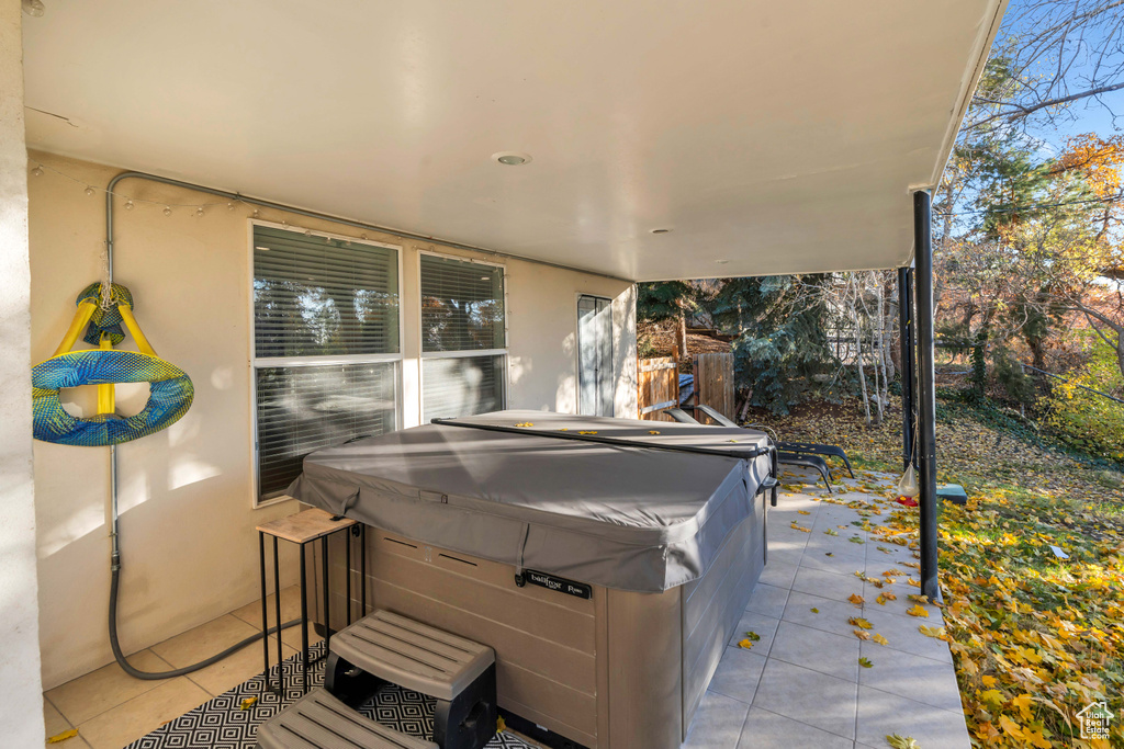 View of patio with a hot tub