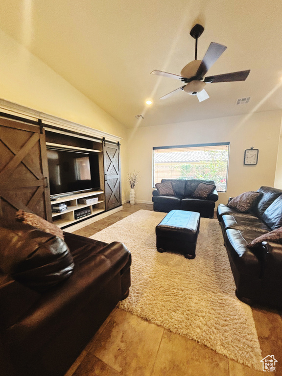 Living room featuring ceiling fan and lofted ceiling