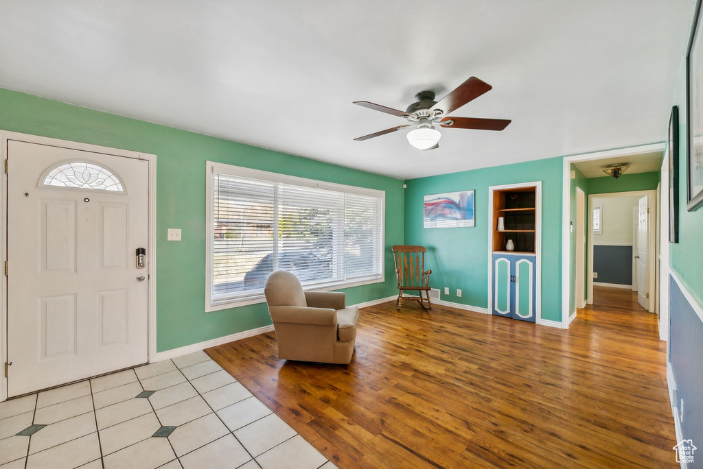 Entryway with ceiling fan and light hardwood / wood-style flooring