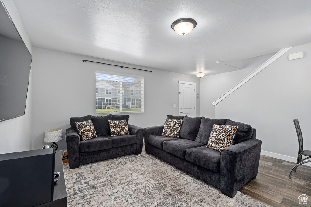 Living room with hardwood / wood-style flooring