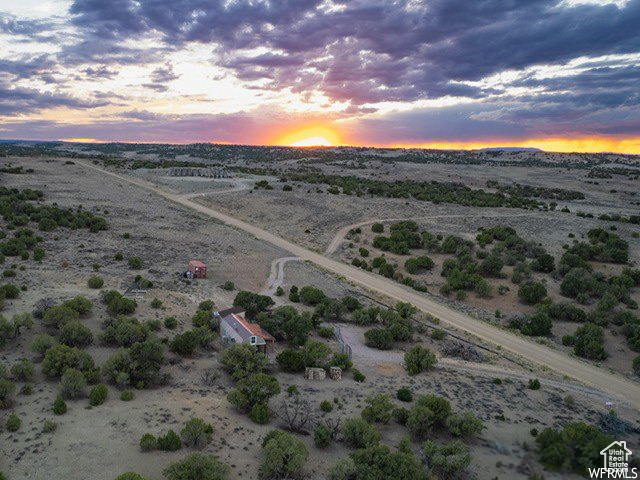 Aerial view at dusk featuring a rural view