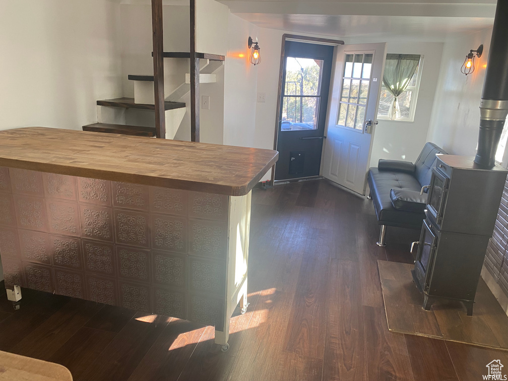 Interior space with butcher block countertops and dark hardwood / wood-style floors