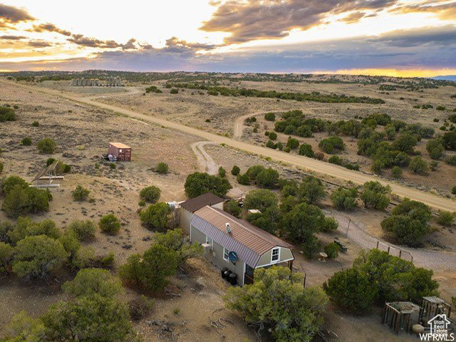 Aerial view at dusk featuring a rural view