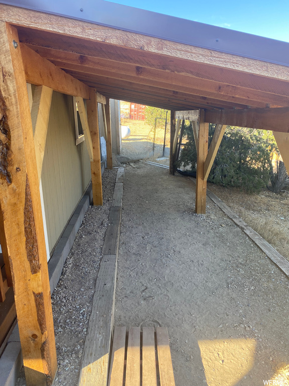 View of parking / parking lot with a carport