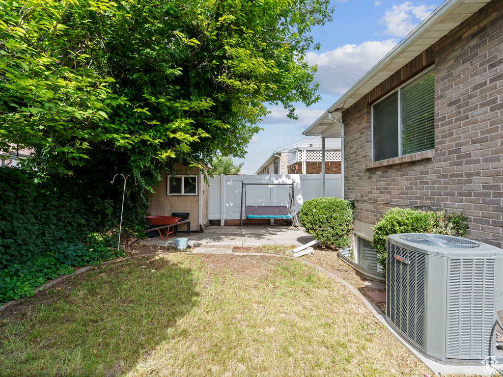 View of yard featuring central AC unit and a trampoline