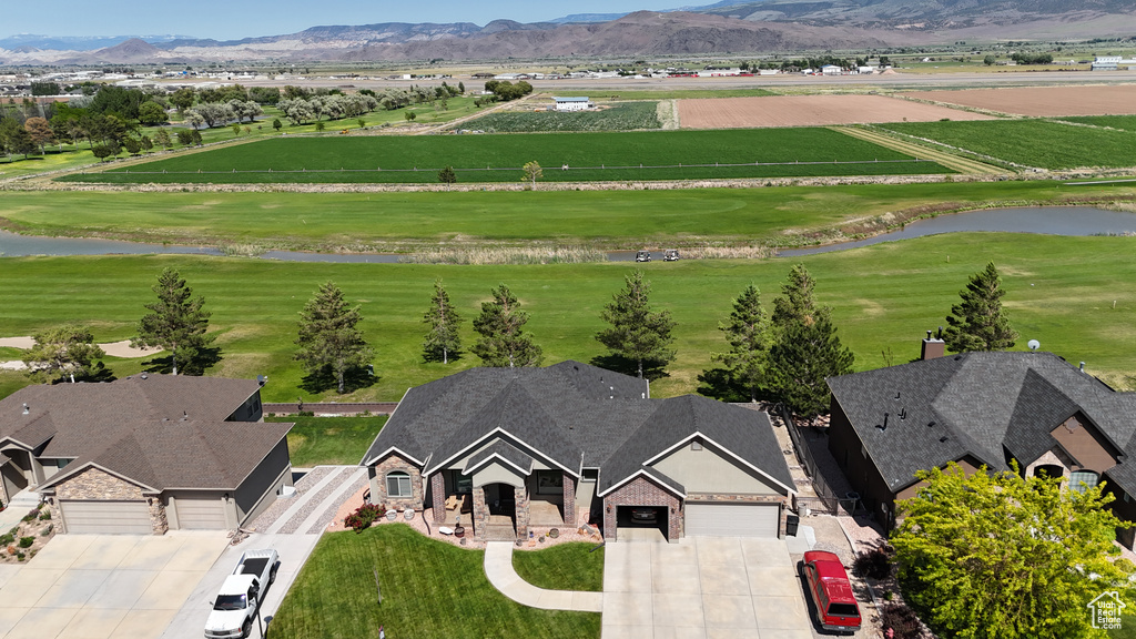 Aerial view of property and surrounding area with a water and mountain view