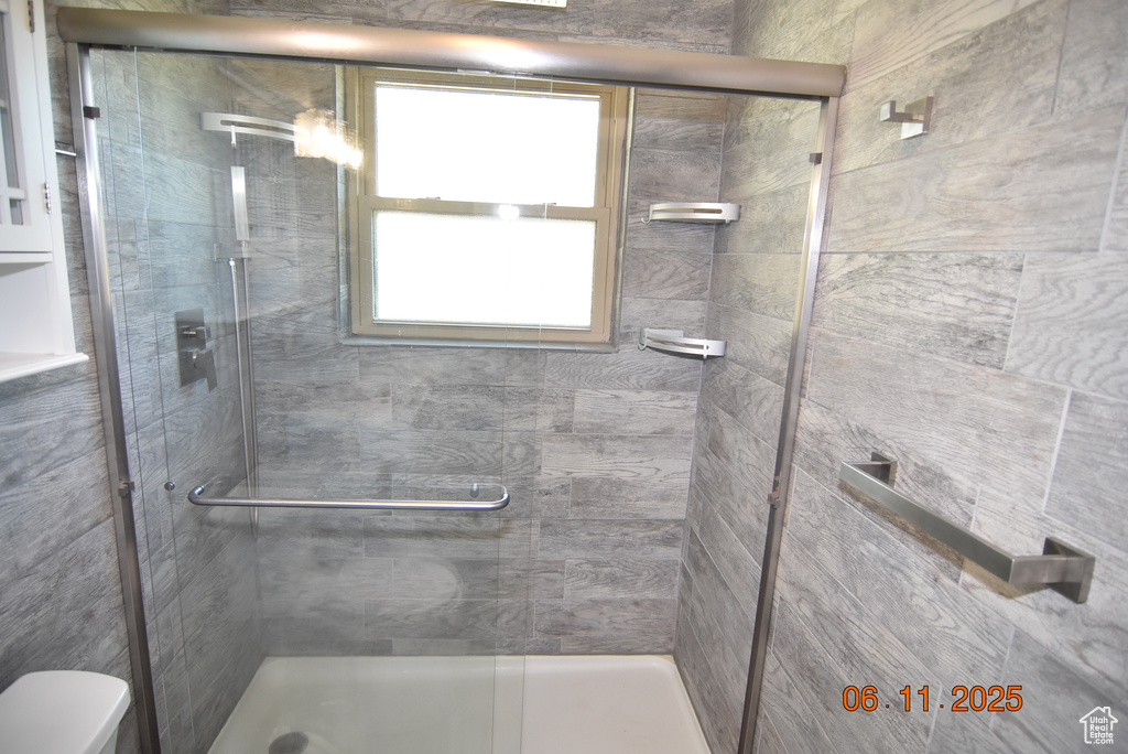 Full bathroom with a stall shower and plenty of natural light