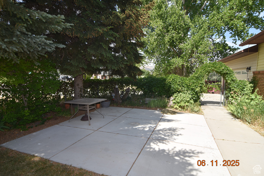View of patio featuring a gate